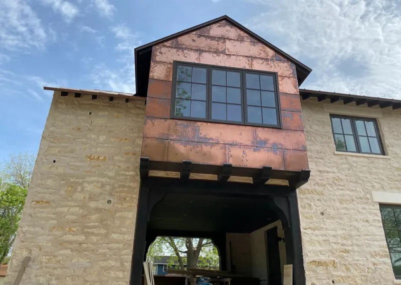 Copper metal panel facade on a stone building for Roof Repair in Tucson Mountains